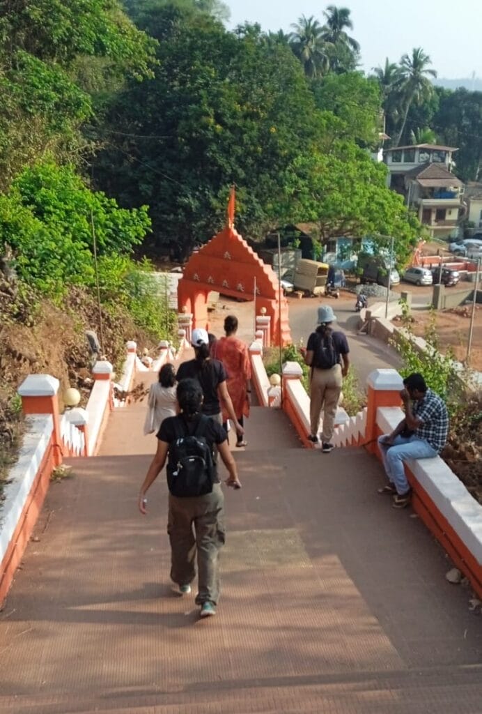 Participants climb down the steps from posh, leafy Altinho towards one of the fountains and dense buildings of Fontainhas.