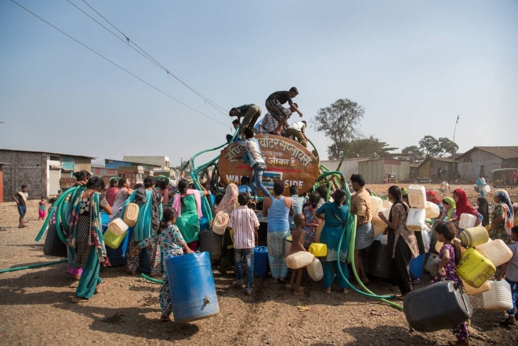 People around a water tanker
