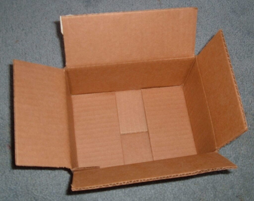 An open cardboard box about to be collapsed