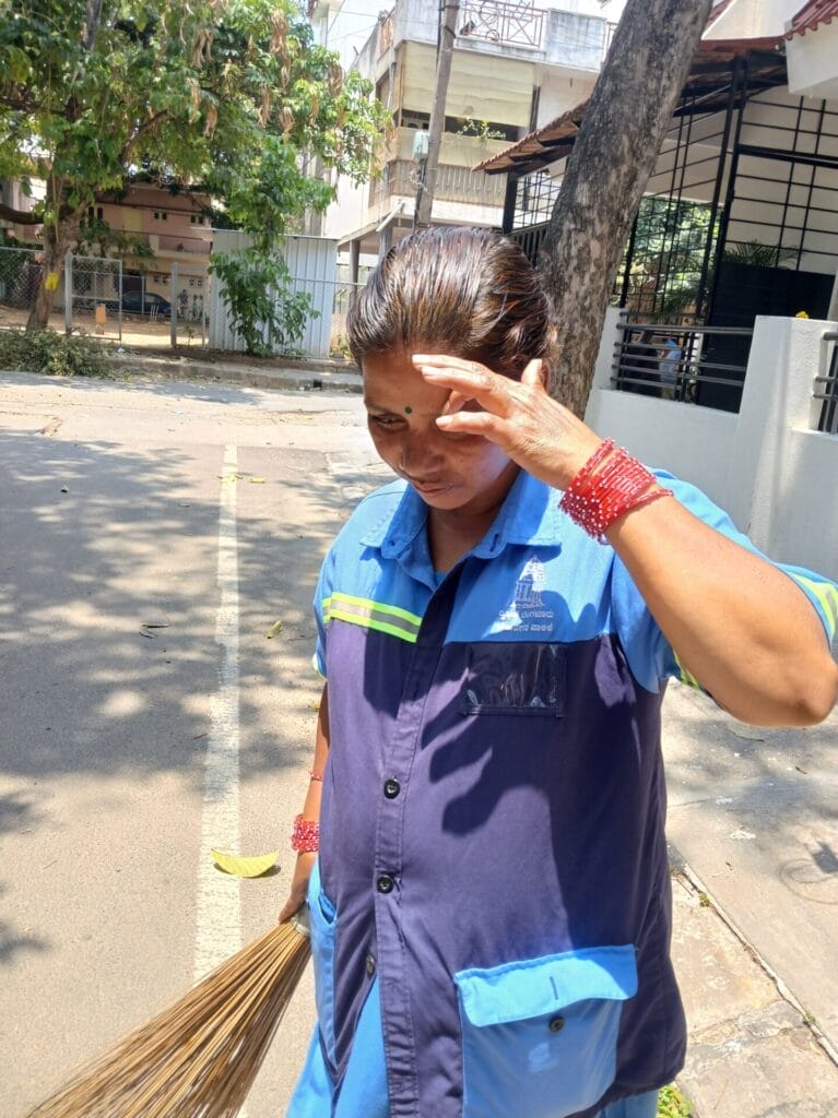 A woman sweeping on the road
