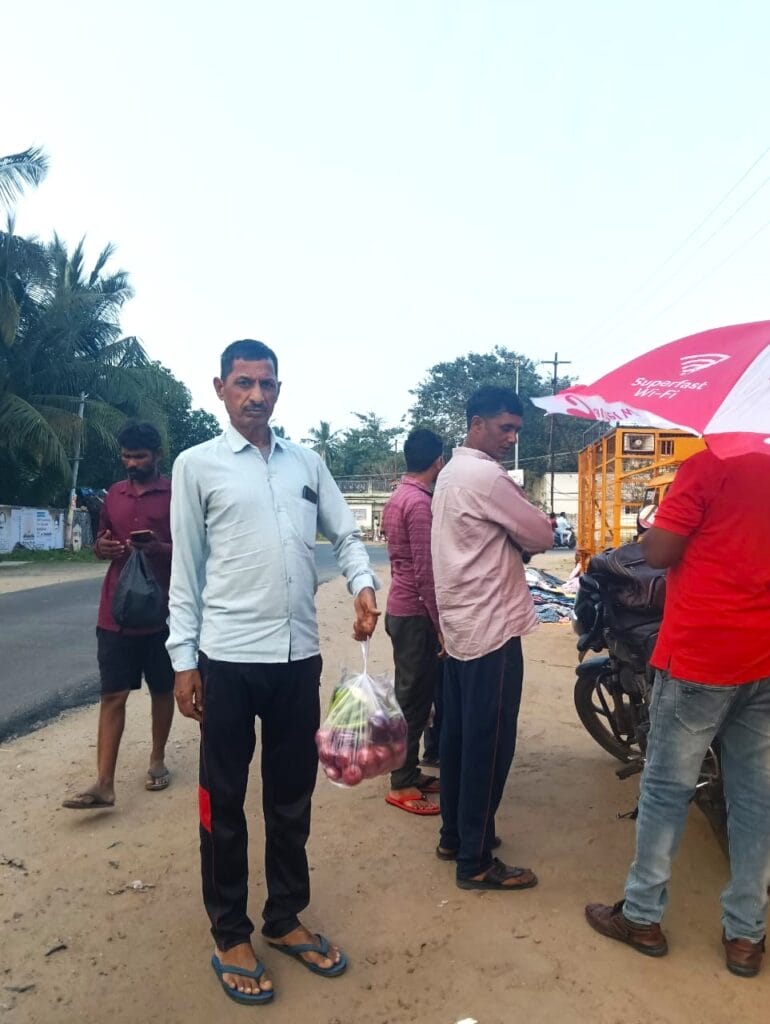 A worker holding a bag of onions that he has brought as week's grocery.